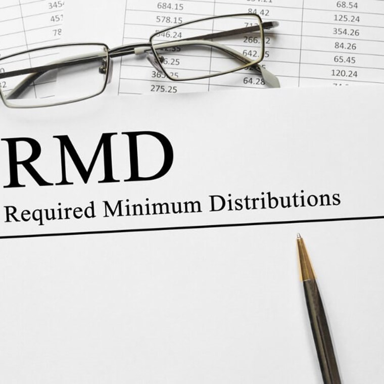 Paper with Required Minimum Distributions RMD on a table