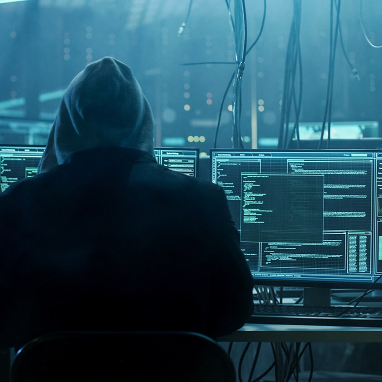 Cybercriminal looking at computers